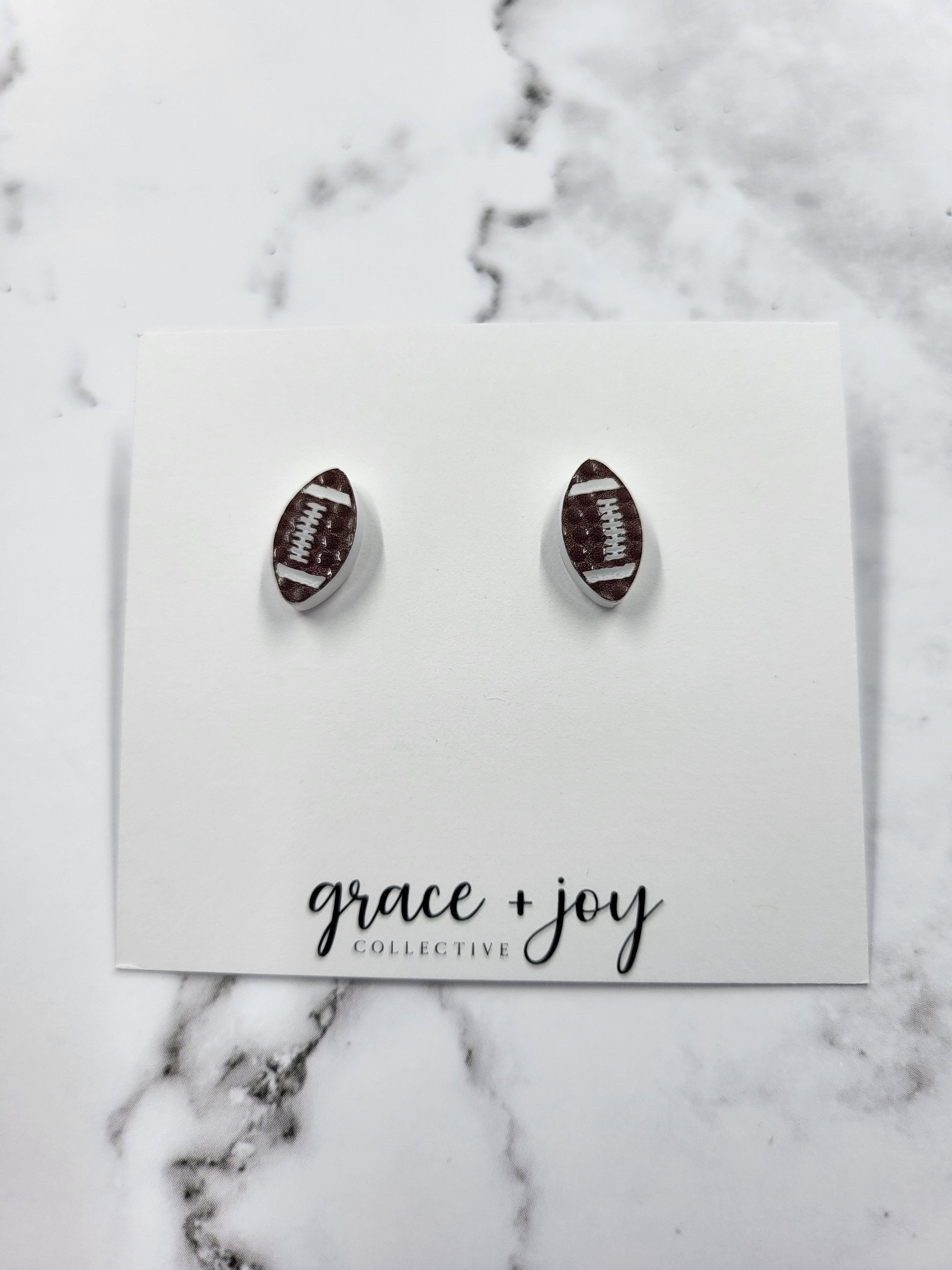 Handmade acrylic football stud earrings—lightweight, hypoallergenic, and perfect for game day. Unique gift for sports fans, moms, and team spirit wear.